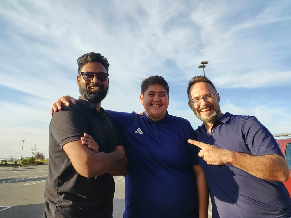 Raj and two teammates sharing a fun moment together outdoors — the spirit of Visma Promotions